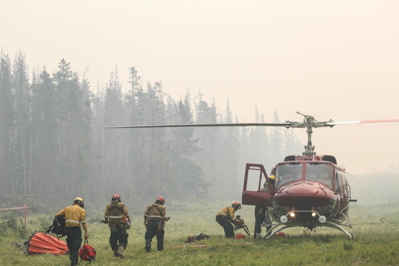 Firefighters prepare a helicopter to fight wildfires during an extremely early fire season in Alberta, May 2023.