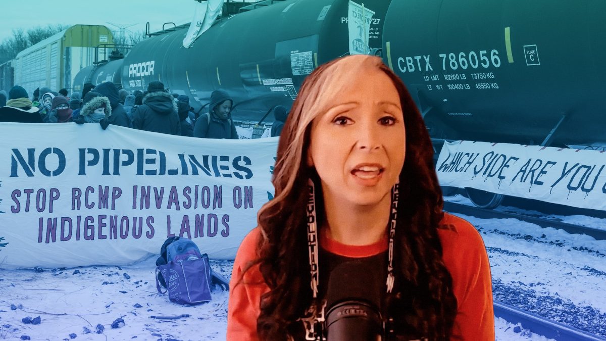 Dr. Pam Palmater, sitting in front of an Indigenous land defence blockade.