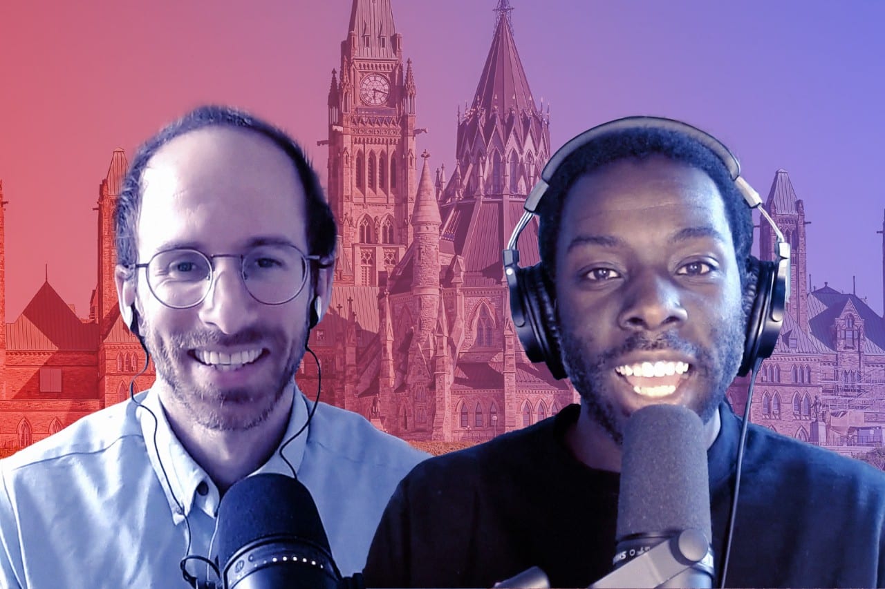 Journalists Desmond Cole and Martin Lukacs smile with Parliament Hill in the background