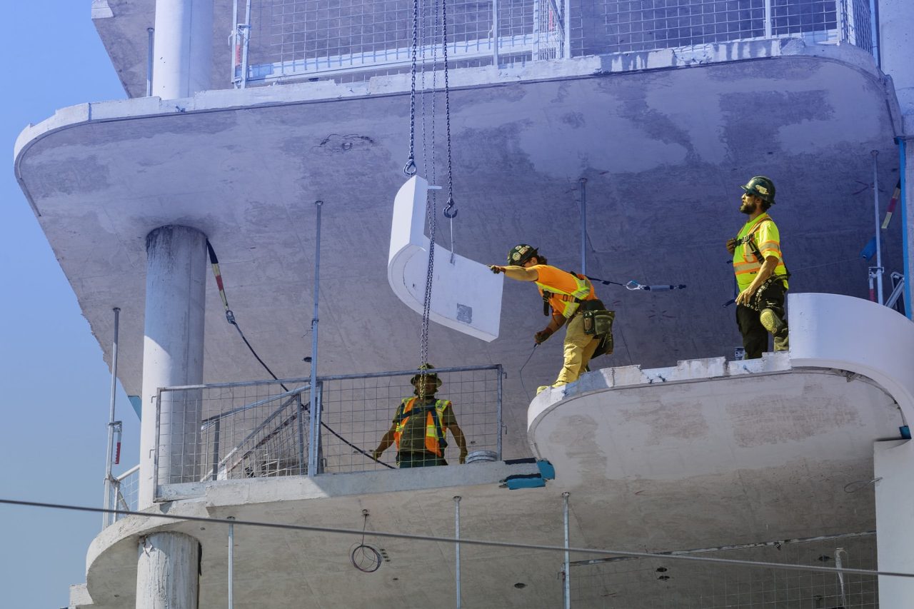 Image of construction workers in hard hats building a condominium building in Toronto